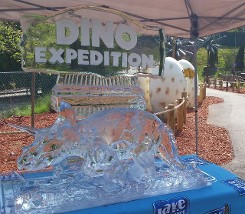 Carved Triceratops in front of Dino Expedition Logo