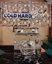 Logo with bills and laminated logo frozen into block, on custom hollow base filled with bills - shown after several hours