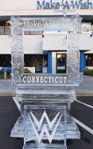 Snowfilled Make a Wish Logo on top of Photo Op, Snowfilled WWE logo in front of photo op - carved snowflake and star accents on frame