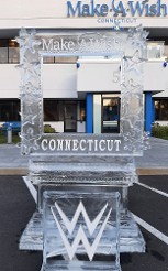 Snowfilled Make a Wish Logo on top of Photo Op, Snowfilled WWE logo in front of photo op - carved snowflake and star accents on frame