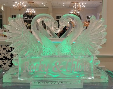 Ice Matters Kissing Swans - horizontal with snowiflled name plaque in front