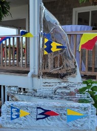 Ice Matters - sailboat with colored burgee on sail and plaque in front with colored burgees