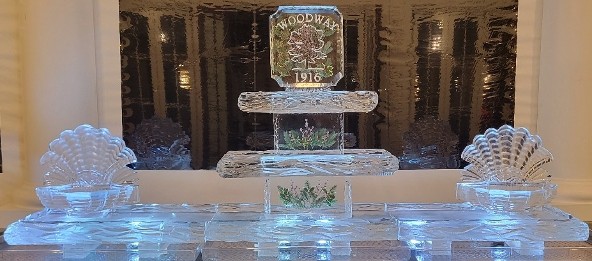 ice matters - festive holiday greens frozen into supports and topper of tiered tray with snowfilled logo and open shell on each end of 120 inch base tray