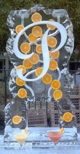 Ice Matters Double Pour Drink Luge with Oranges frozen into block and snowfilled letter, rocky edges