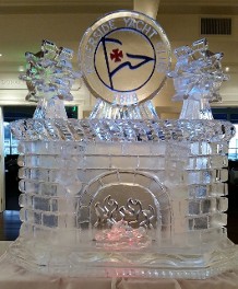 Fireplace with Tony Carved Ships Wheels and Colored Burgee Logo